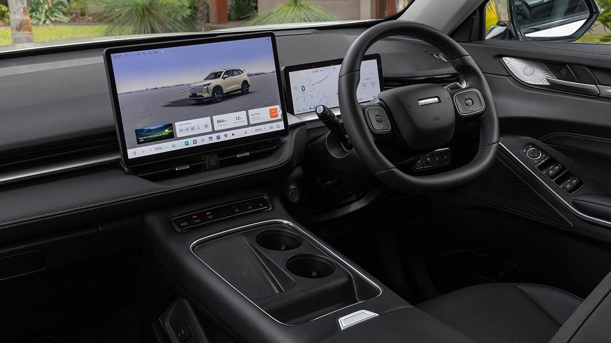 Driver's cockpit area of GWM Haval H6 Ultra PHEV SUV with large central touchscreen and smaller digital instrument display.