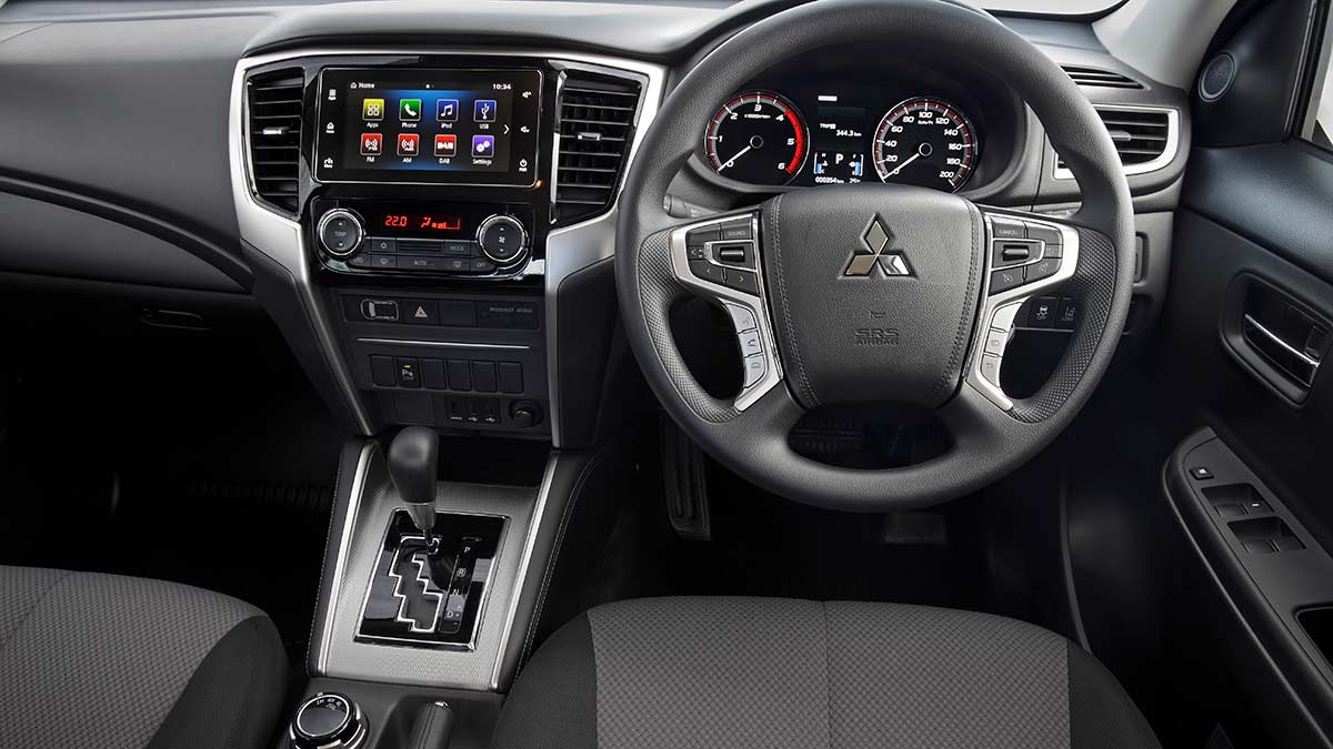 A Mitsubishi Triton's dash layout and steering wheel