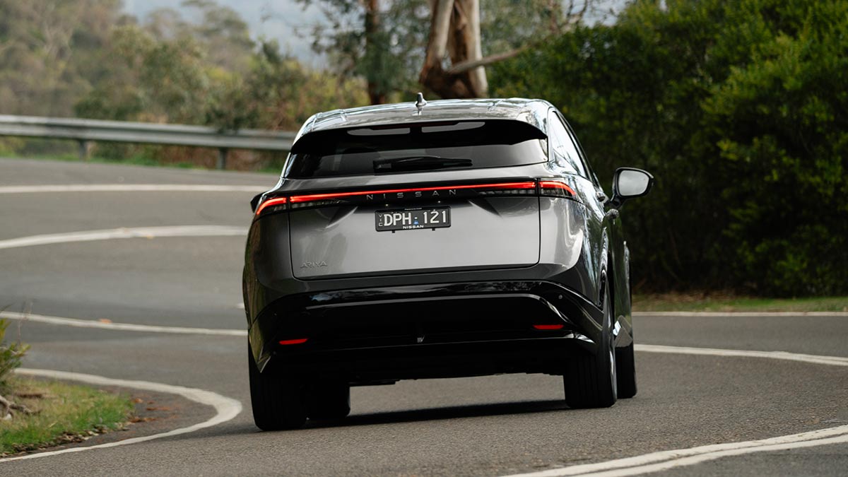 Rear of grey Nissan Ariya Advance+ SUV on winding road on Victoria's Mornington Peninsula.