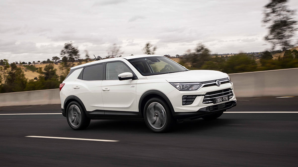 Front side view of a white SsangYong Korando Ultimate 2020 car driving on a road