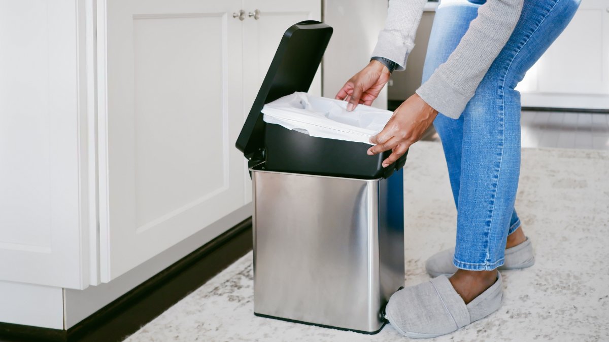 woman replacing kitchen bin liner