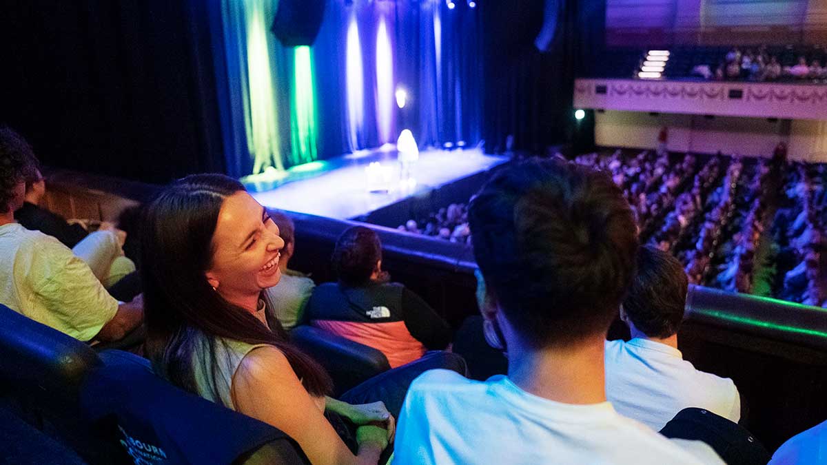 Two people laughing at comedy show