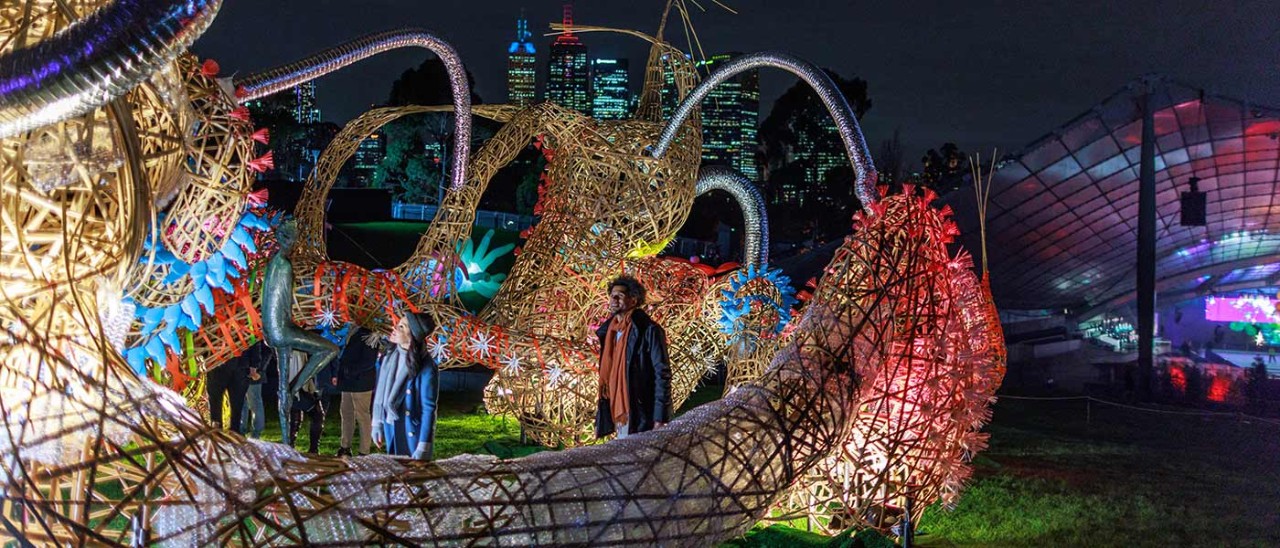 Rising-festival-Visit-Victoria-157463-56.jpg People interacting with large woven sculpture that's lit up at night