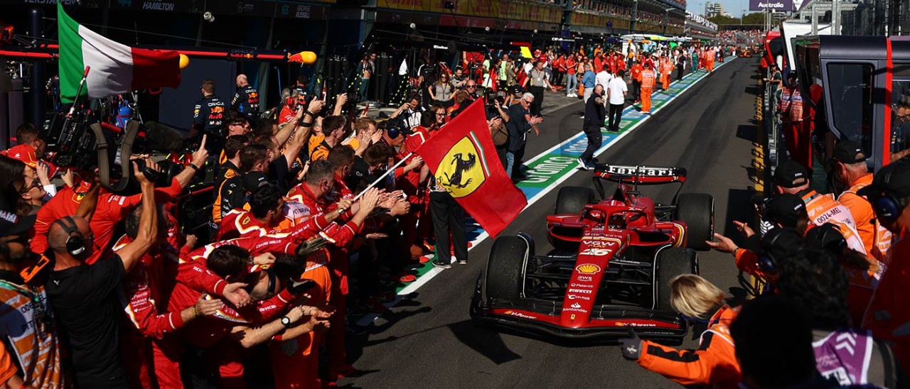 F1 car off track surrounded by crowd clapping