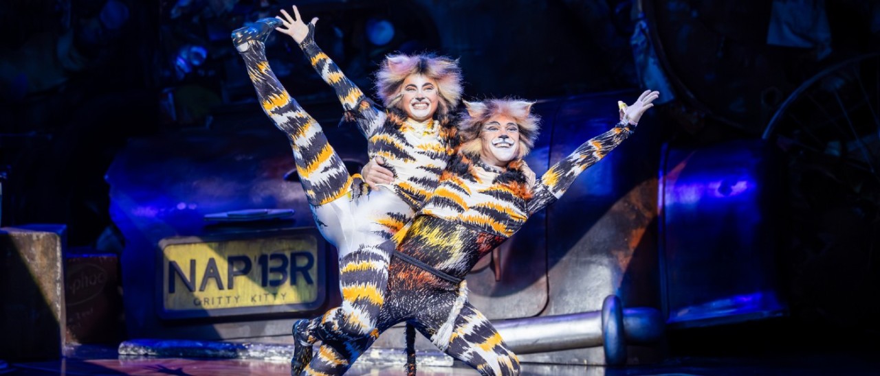 Two performers embrace as part of CATs the musical 
