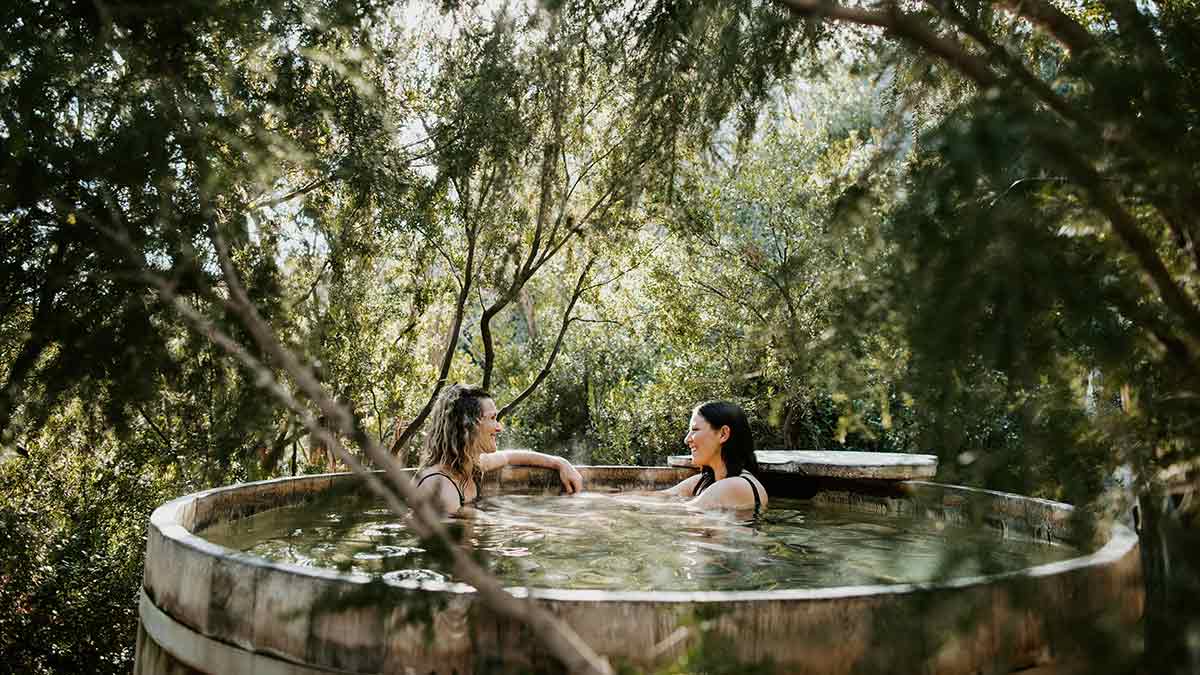 Couble bathing in tub at Peninsula Hot Springs