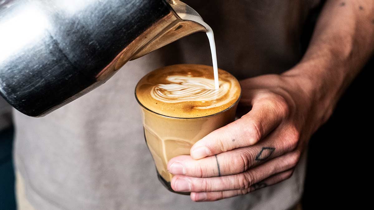 Barista pouring a latte with foam art