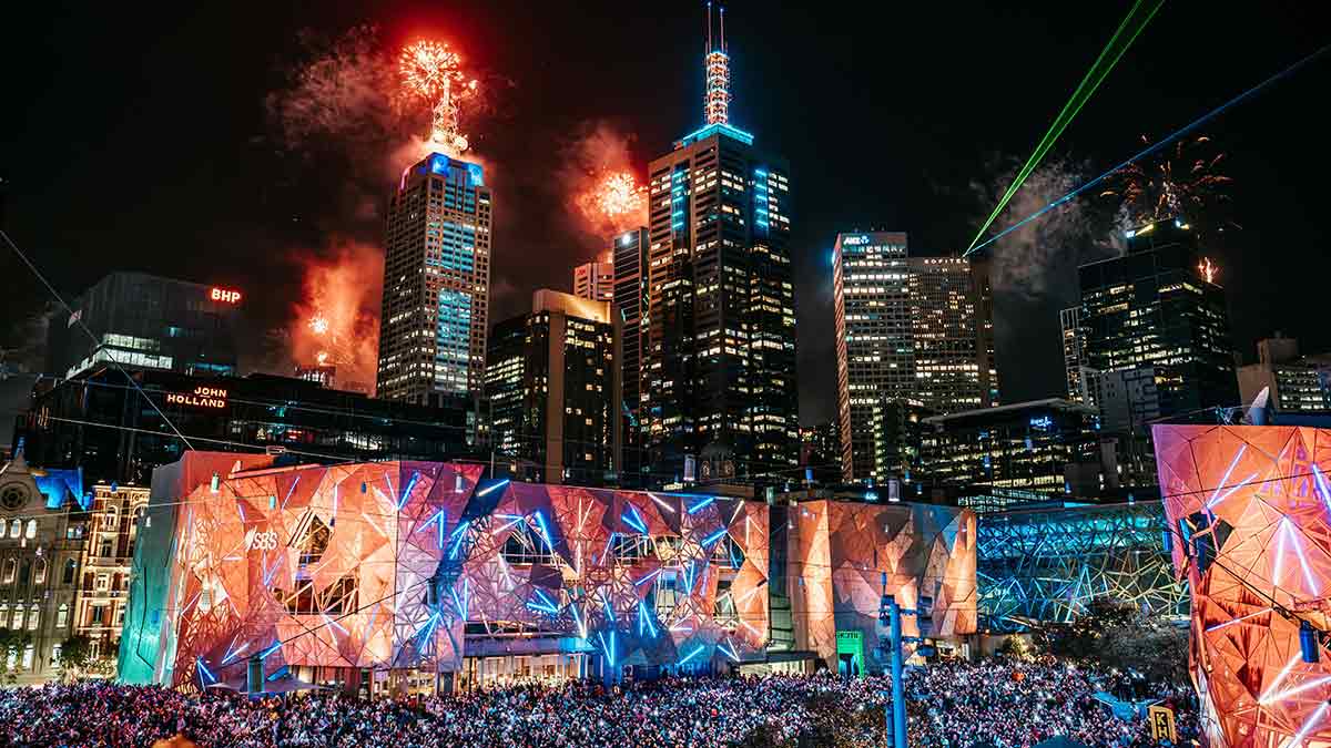 Crowd gathered at Federation Square in Melbourne for fireworks display.
