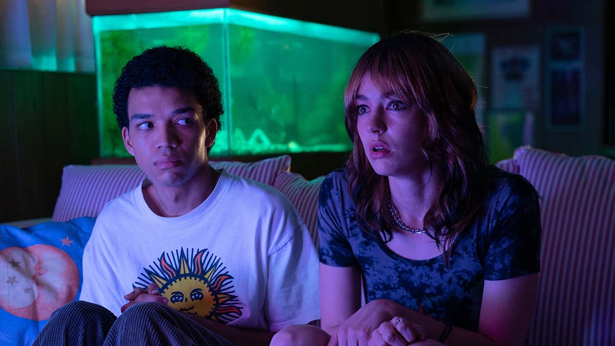 Two actors sitting on couch looking afraid in movie I saw the TV glow