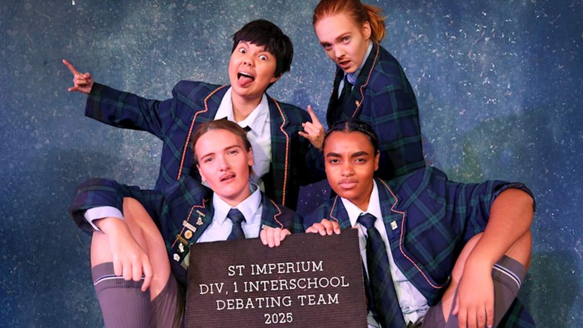 five female actors in drag on stage playing schoolboys