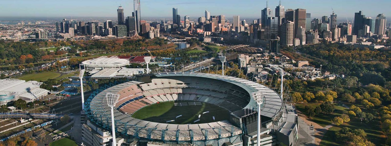 Aerial view of MCG with Melbourne CBD in background.
