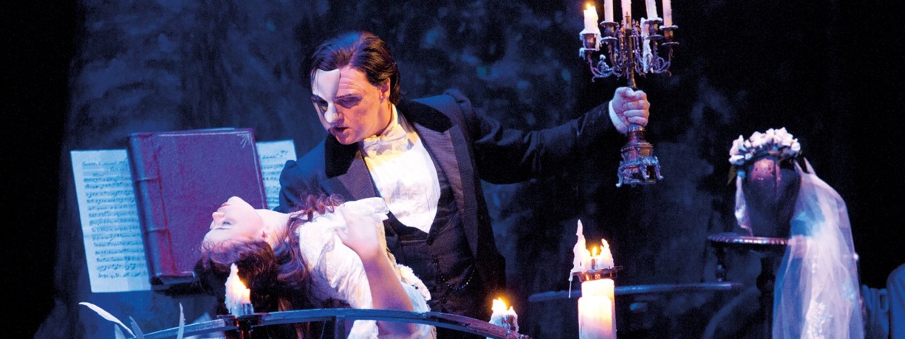 The Phantom of the Opera holding Christine