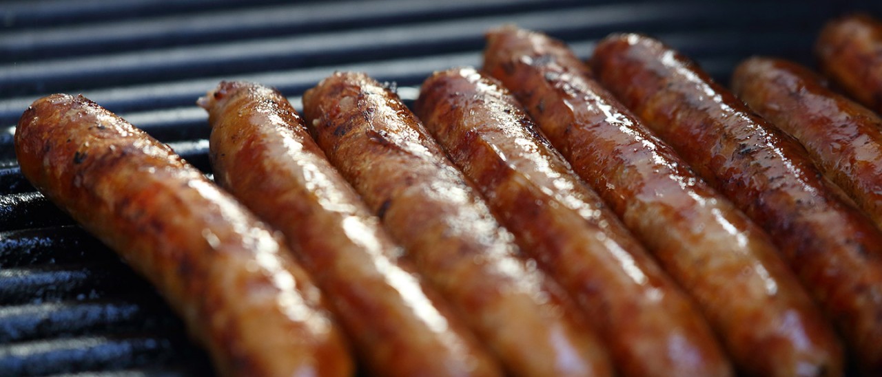 Close-up of sausages cooking on a BBQ grill