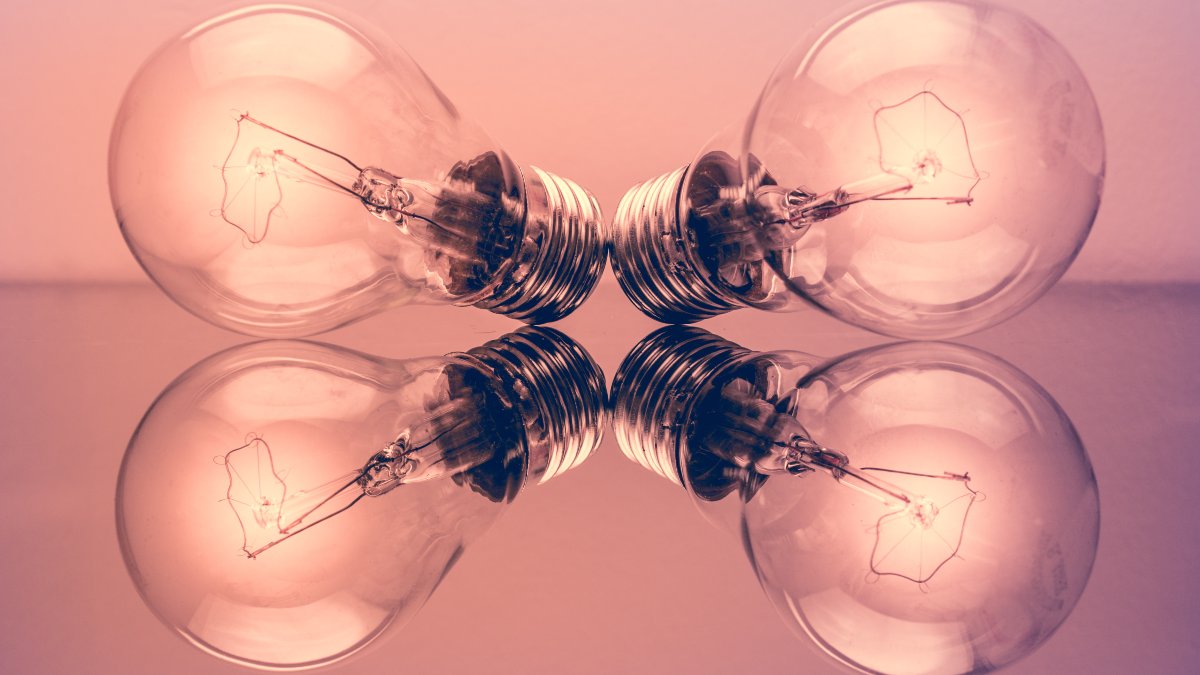 two light bulbs placed on a reflective surface