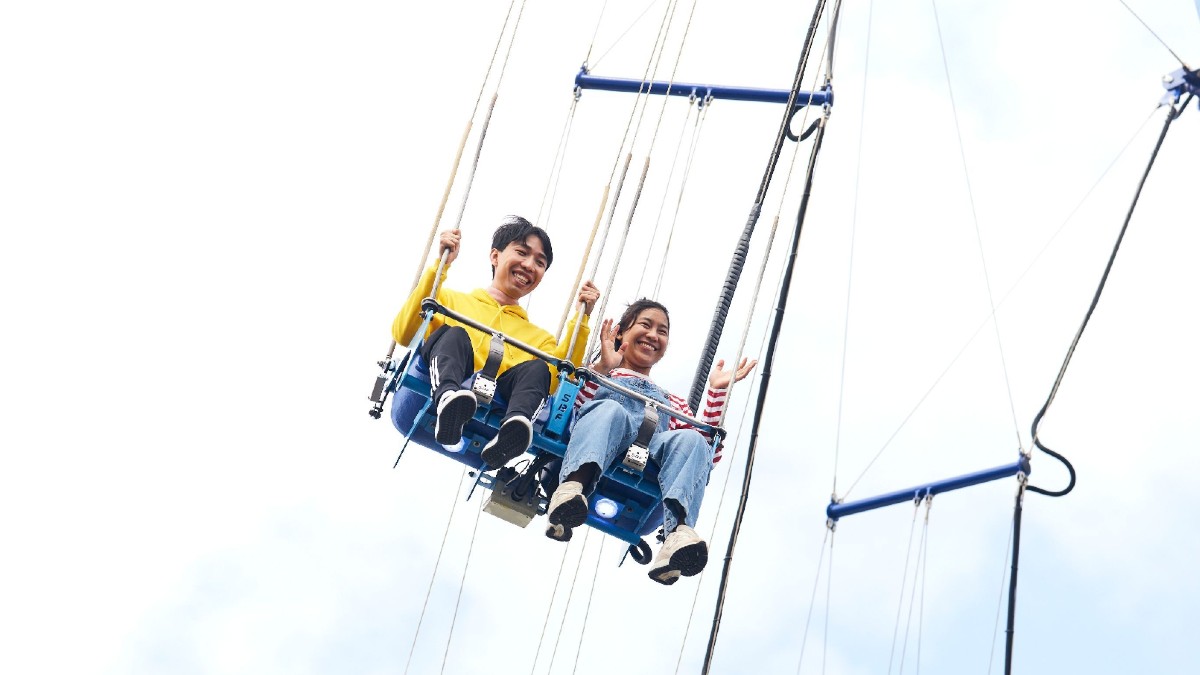young couple on swing ride at Luna Park