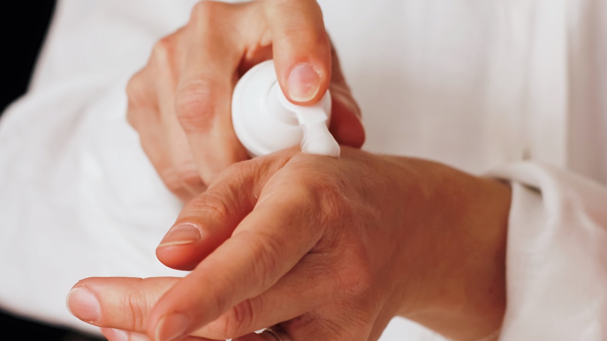 Person applying lotion to hands