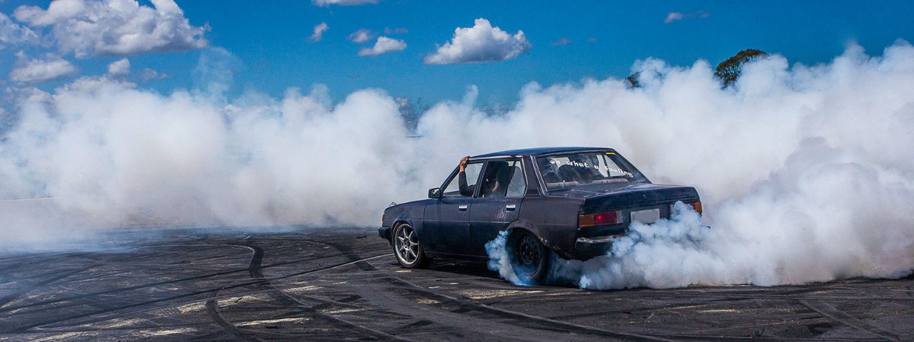 Car smoking at its wheels while doing donut