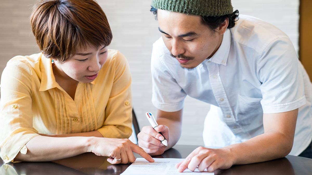 A man and woman filling out a form
