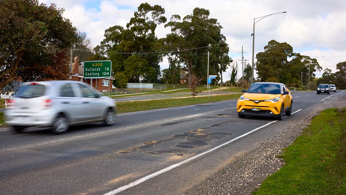 Cars driving on a section of the Midland Highway between Daylesford and Ballarat where there is a visibly poor road surface