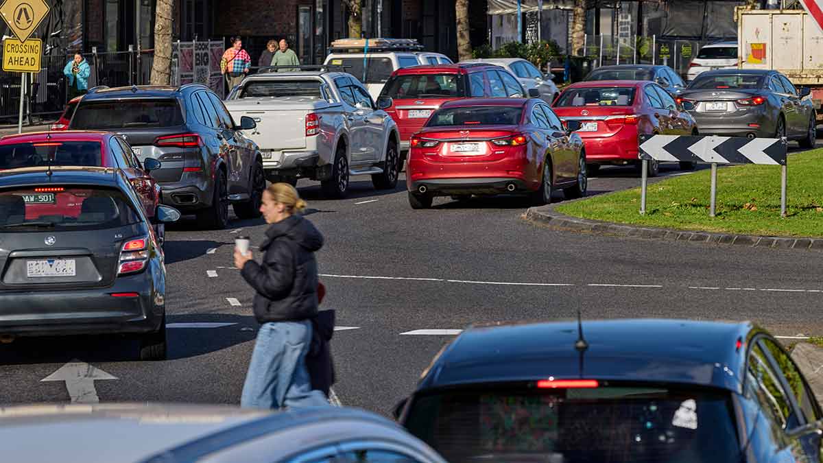 Woman walking across busy road