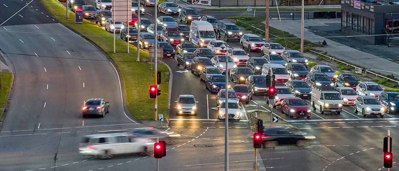 Long line of traffic stopped at red light at intersection