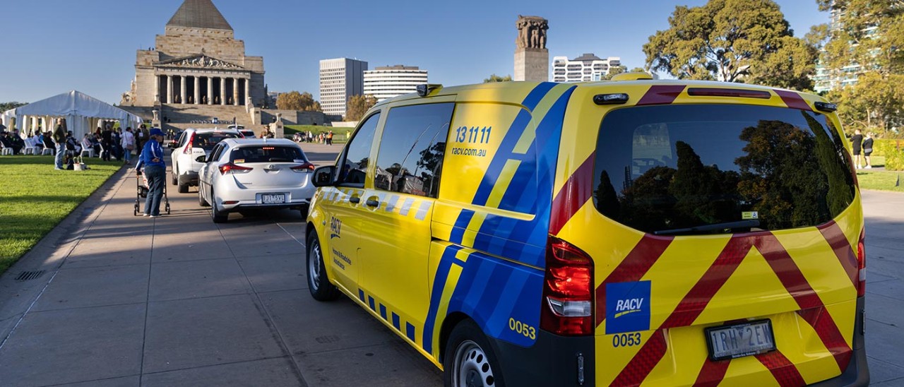 RACV van in Anzac Day parade with Melbourne's Shrine of Remembrance in the background.