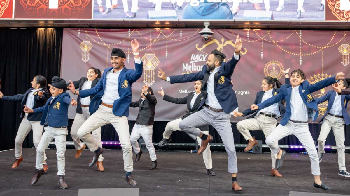 group of young Indian people performing a cultural dance