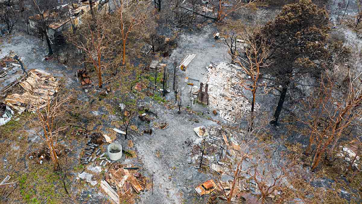 Aerial view of destroyed homes in wake of bushfire.