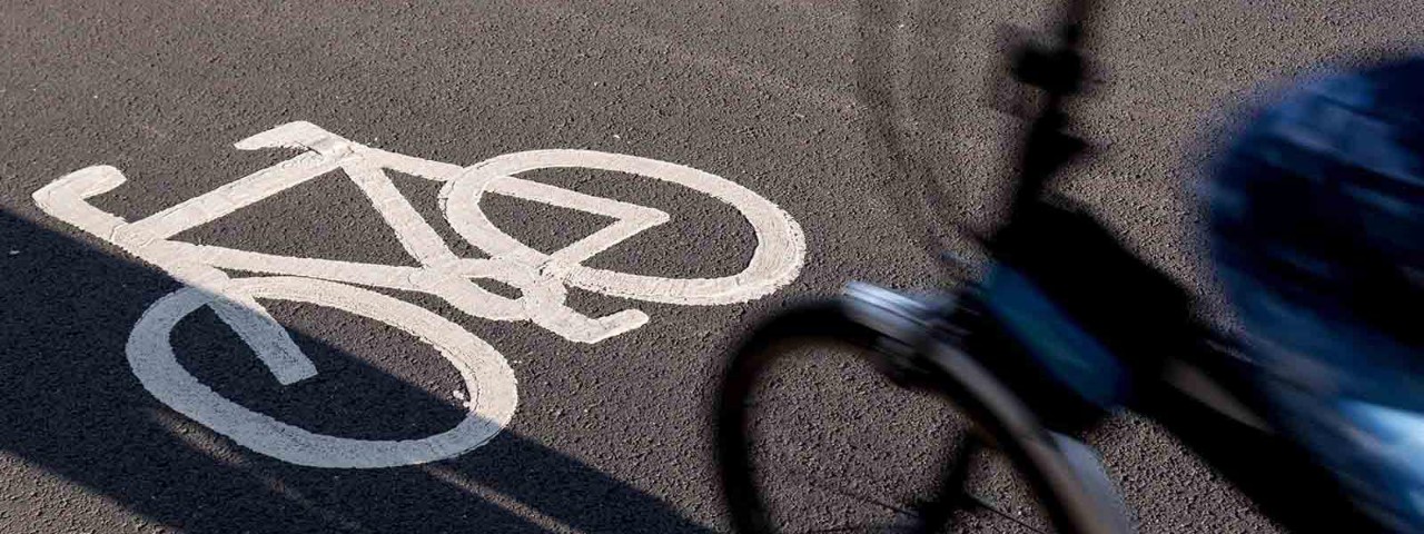 Bike riding along road's bicycle lane