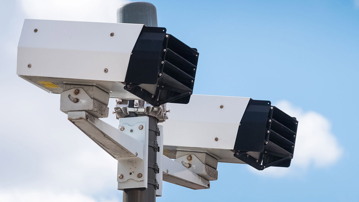 Speed cameras in front of a partly cloudy sky