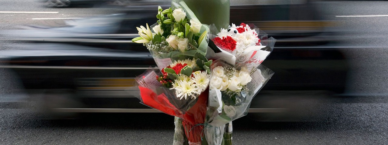 522156282 Lamp post memorial with flowers