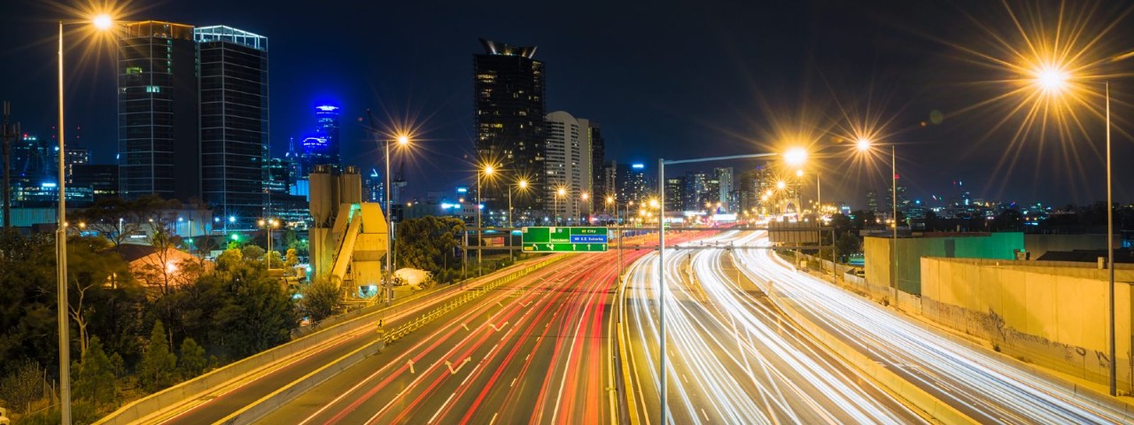 A Melbourne motorway at night, with streaks of light representing cars going by