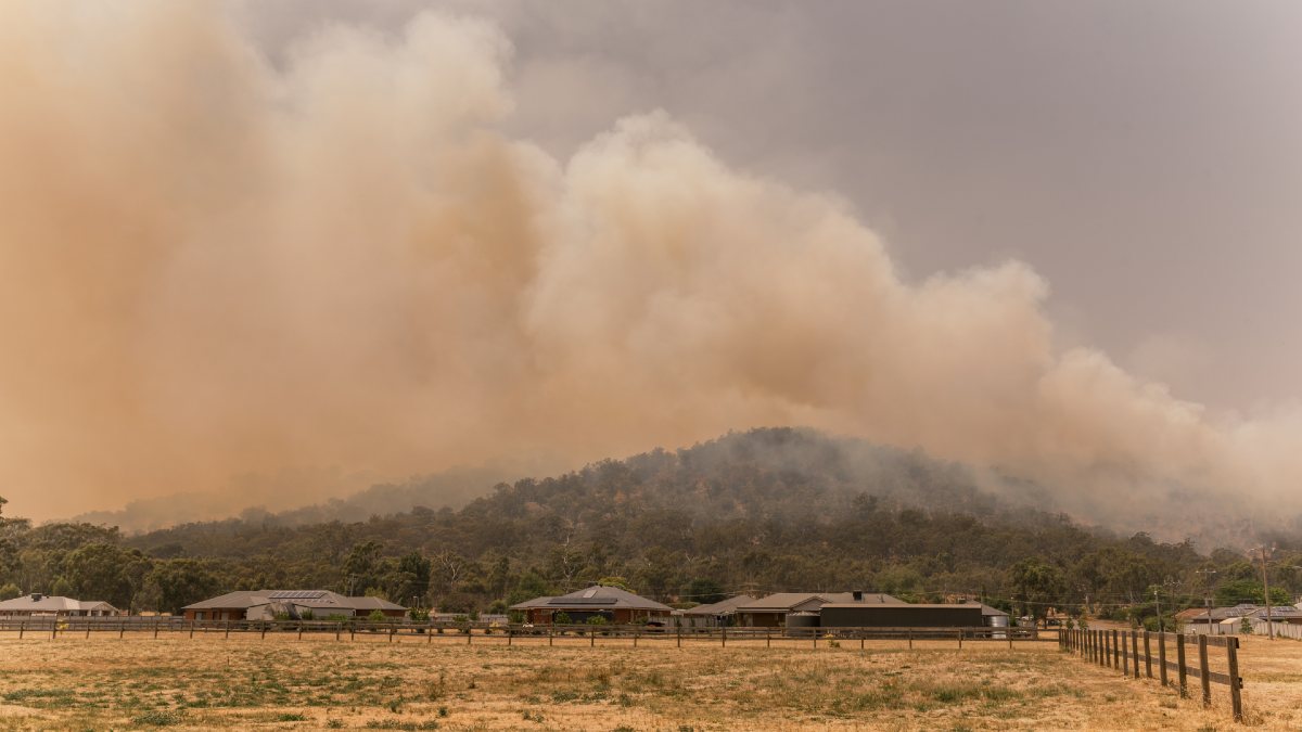 bushfire with lots of smoke approaching a country town