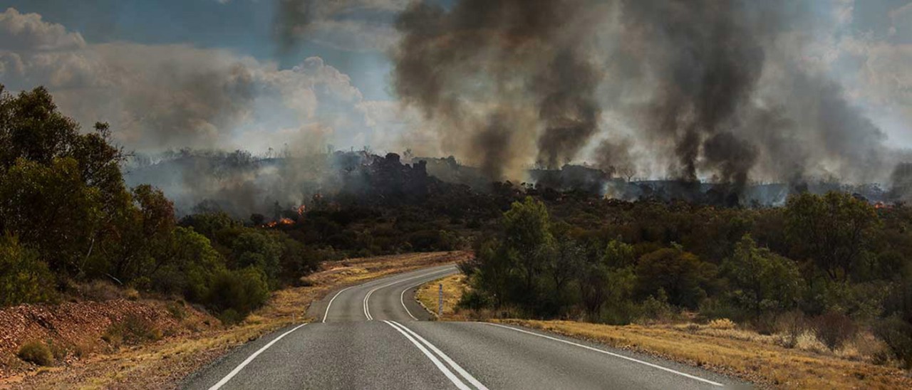 Bushfire surrounding road in East McDonnell Ranges in Alice Springs