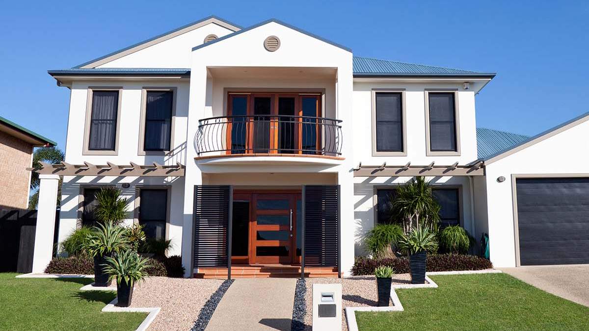 two story house with white paint and wooden doors