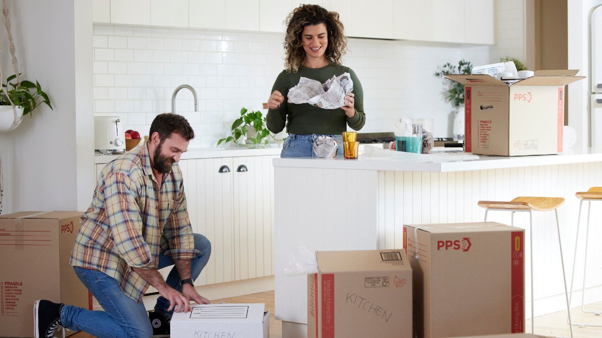 A couple unpacking boxes in a new house