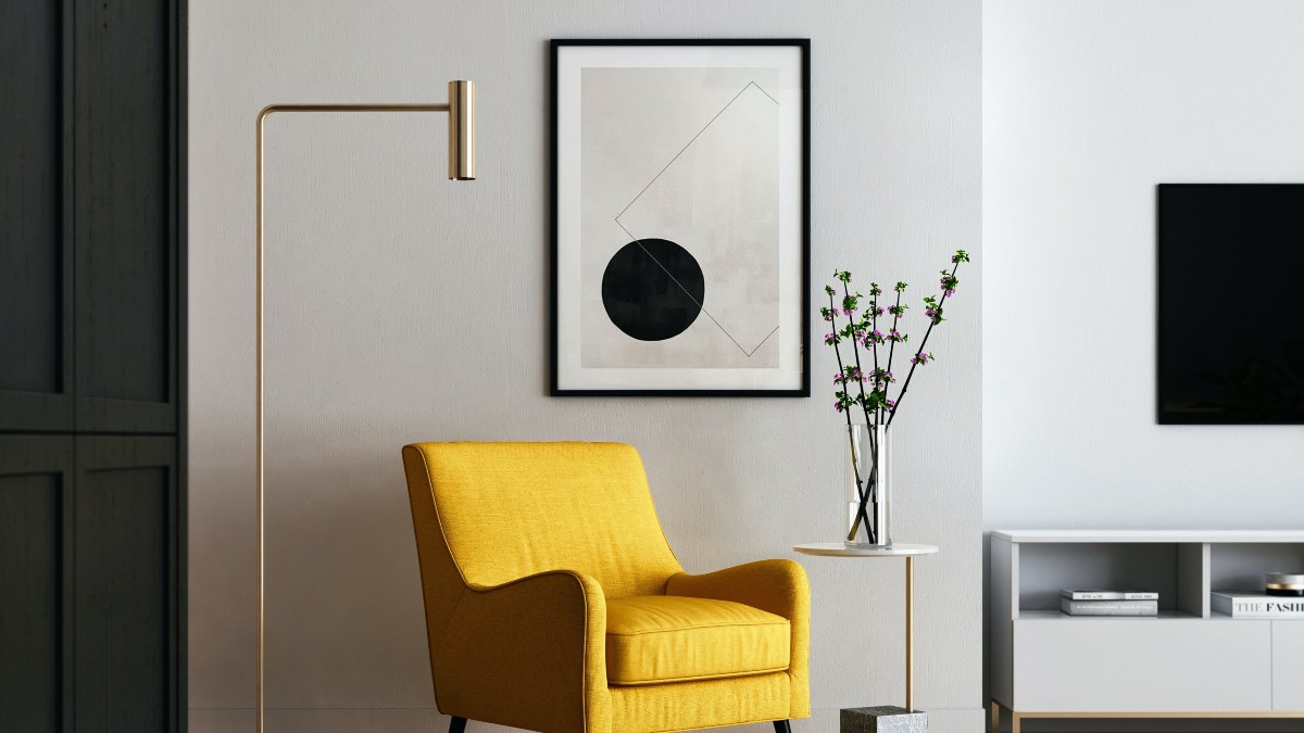 living room with yellow chair and modern art and gold lamp