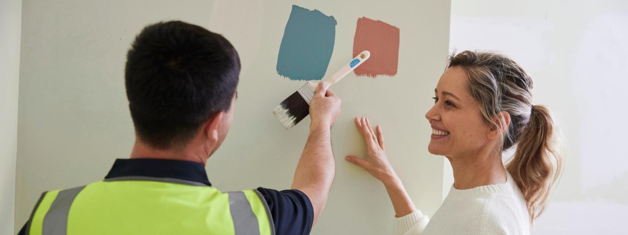 Woman and man deciding between colours for a wall