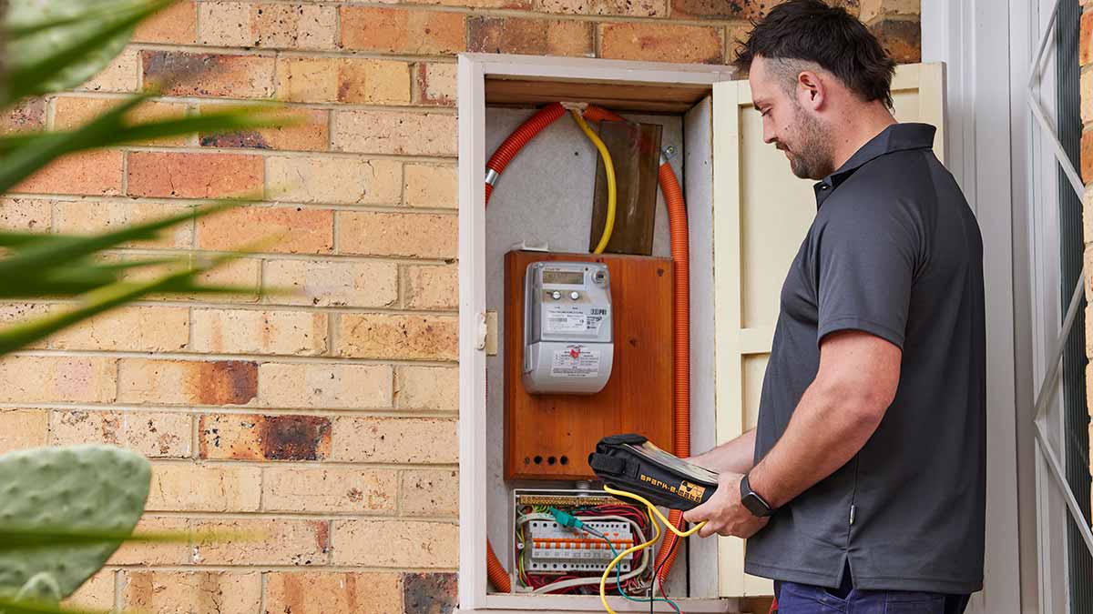 Electrician checking domestic switchboard.