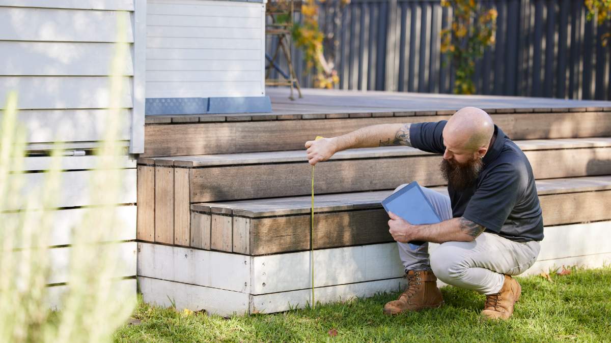 property inspector measuring exterior steps