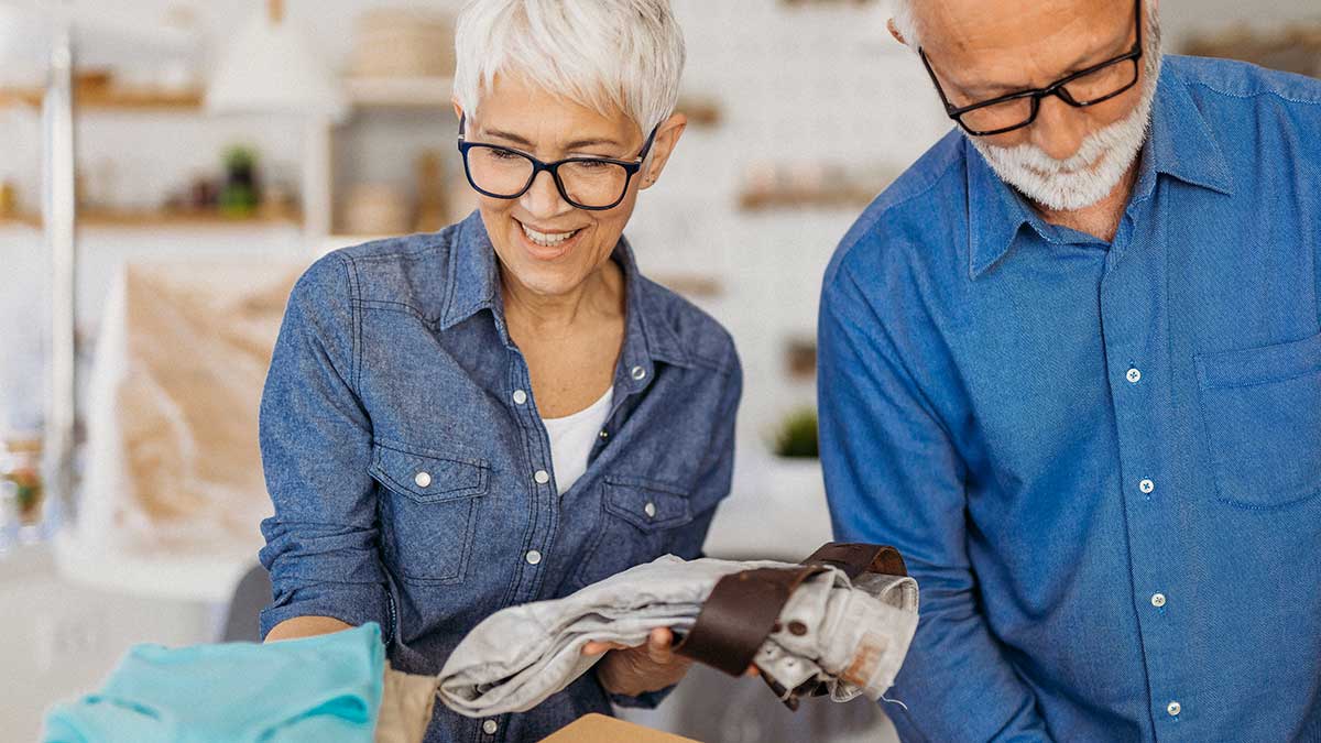 Couple packing boxes to move house 