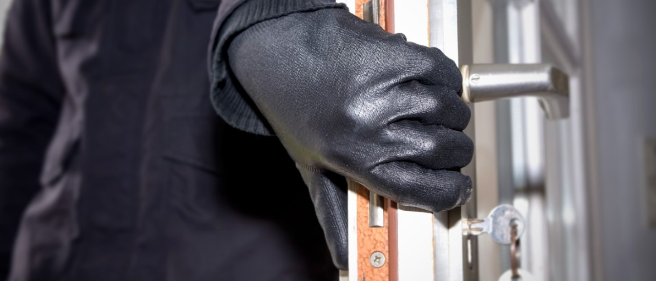 Burglar_Getty burglar wearing leather gloves opening an unlocked house door