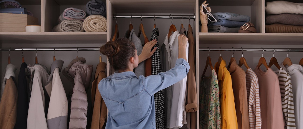 Bedroom-Wardrobe-Getty-Images-1425540760-banner-1400x600 Young woman with brown hair and blue shirt choosing white shirt on hanger from wardrobe