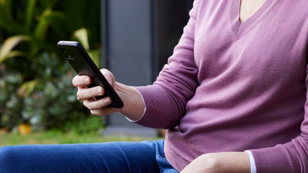 woman looking at smartphone on a Melbourne street