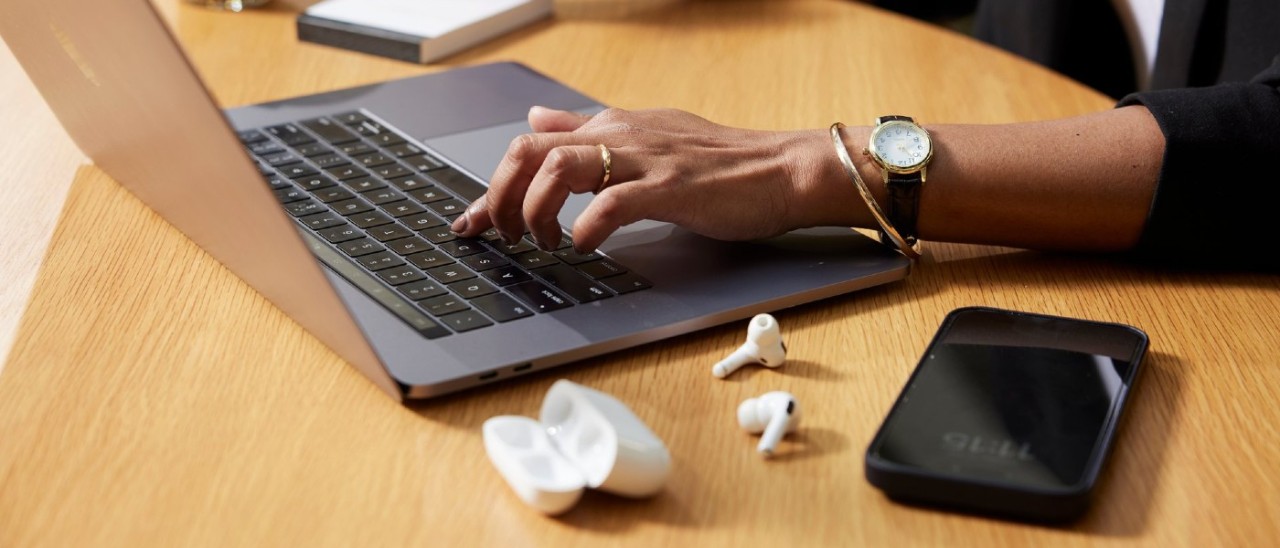 Portable Items Insurance items: a laptop, jewellery and phone A close-up of a person working on a laptop. They're wearing a gold bangle, ring and watch and have a pair of earbuds and a smartphone next to them on their desk