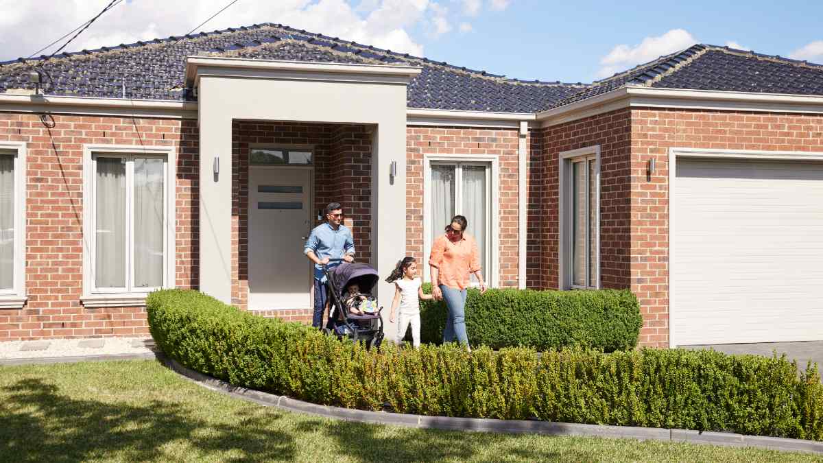 family walking out of their modern home