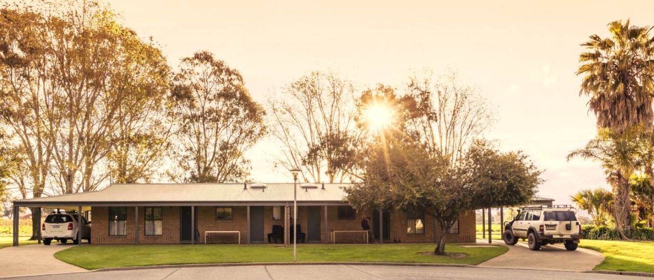 exterior shot of brick home with two cars