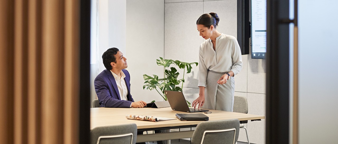 RACV-city-business-centre-D1-S10-709-1400x600 Professional woman presenting in business centre with laptop to male client seated at table