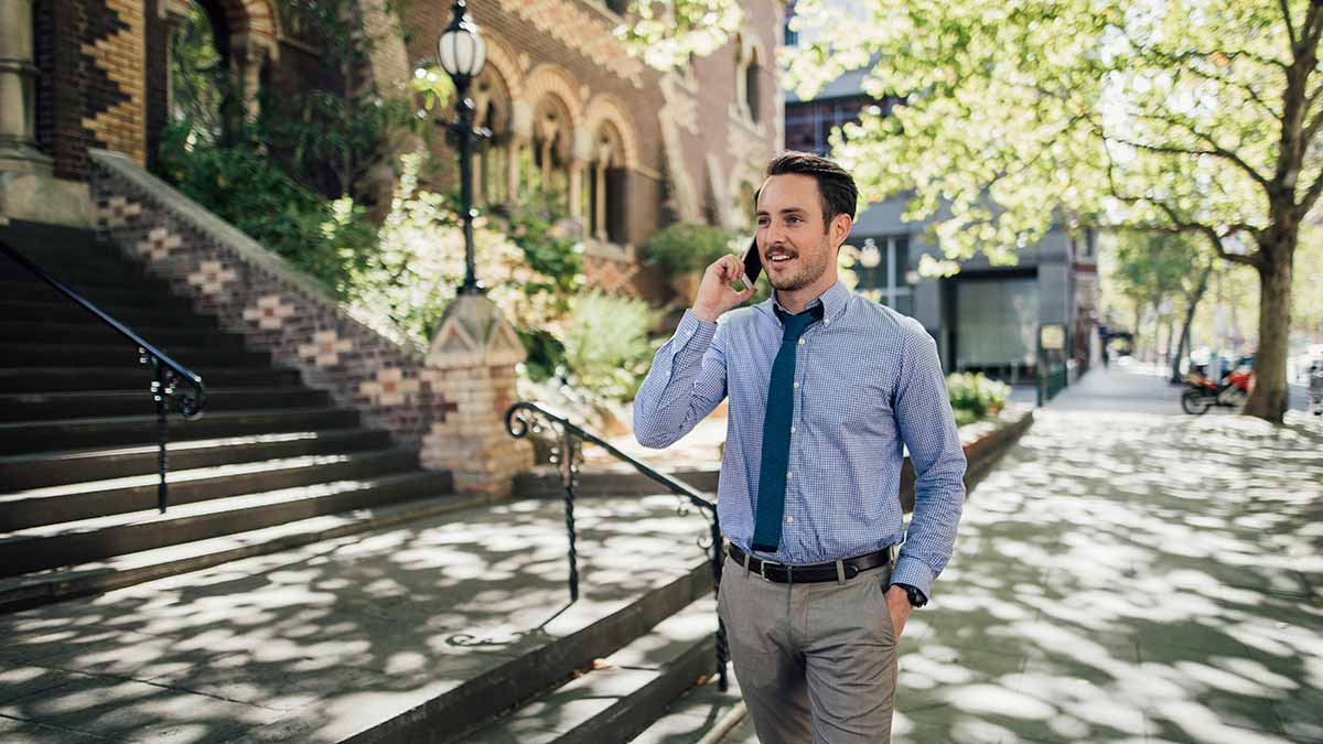 Man walking down Melbourne street talking on phone