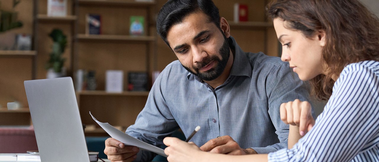 Professionals-Getty-1314904477-banner.jpg Professional man and woman working together at desk with laptop